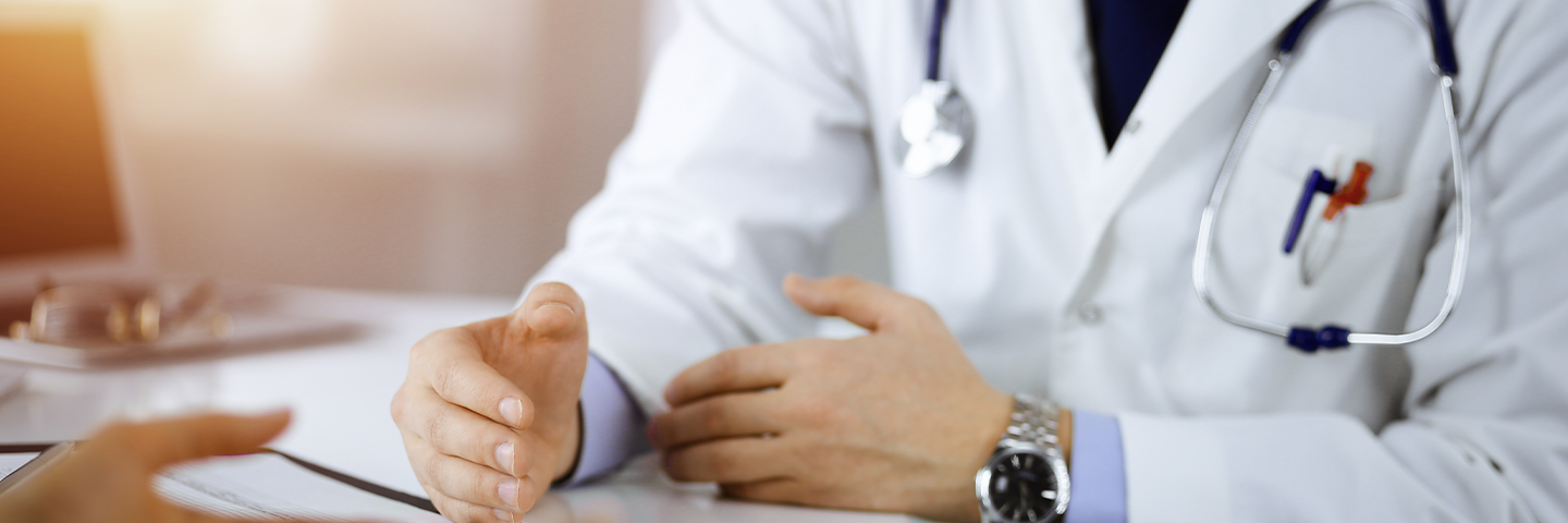 Doctor talking to patient in office