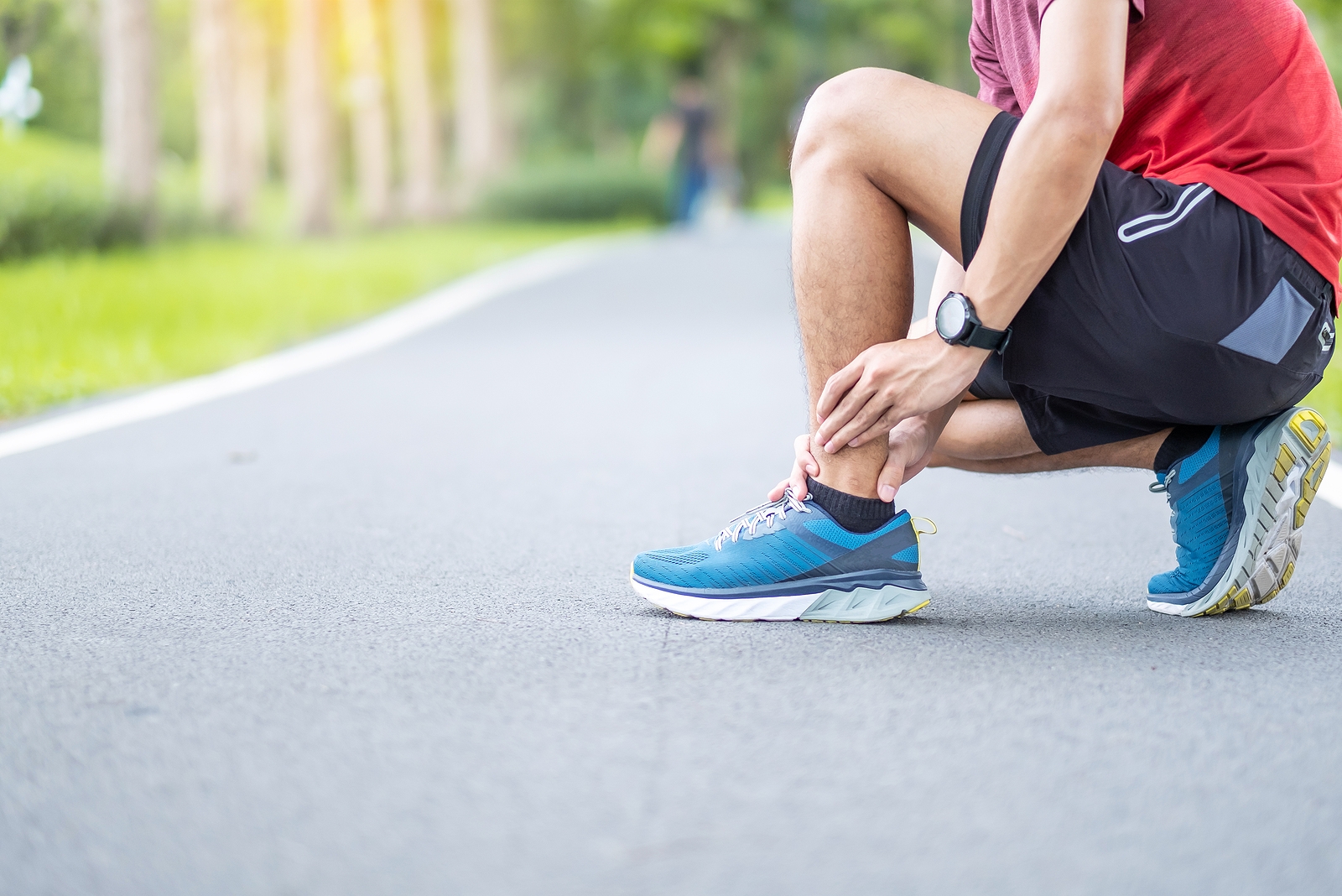 Injured runner suffering from ankle or achilles sprain