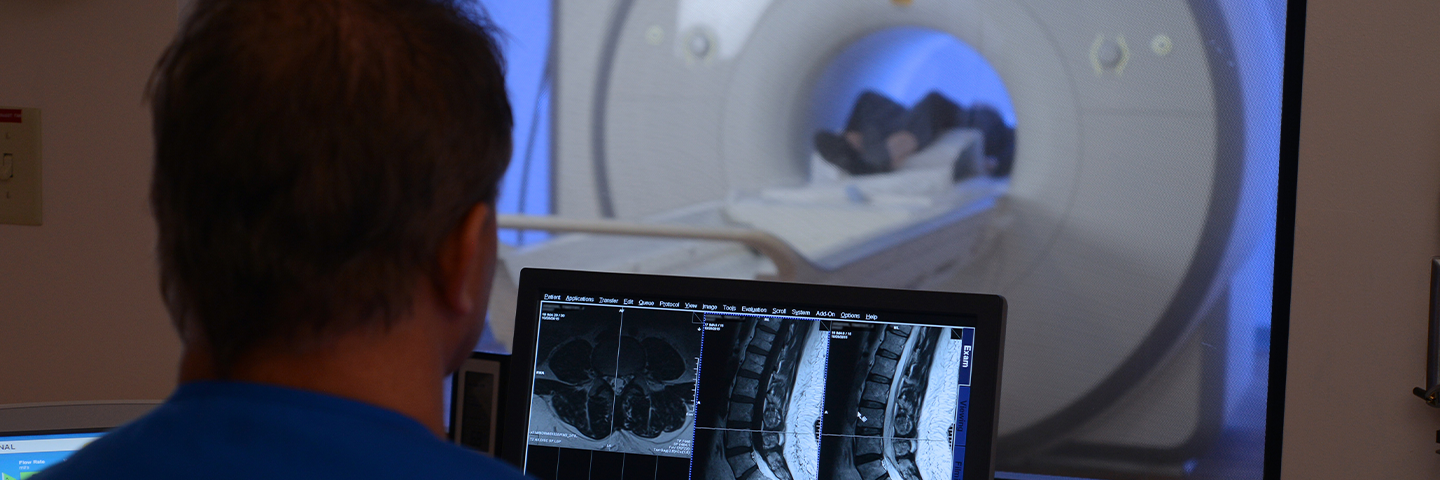 Person looking at patient in MRI machine