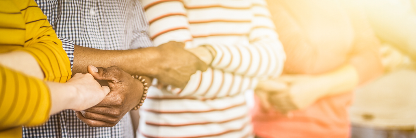 Group of adults holding hands