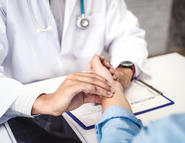 Doctor checking pulse on patient